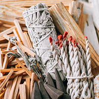 A collection of sage smudge sticks, natural matches, incense and palo santo.