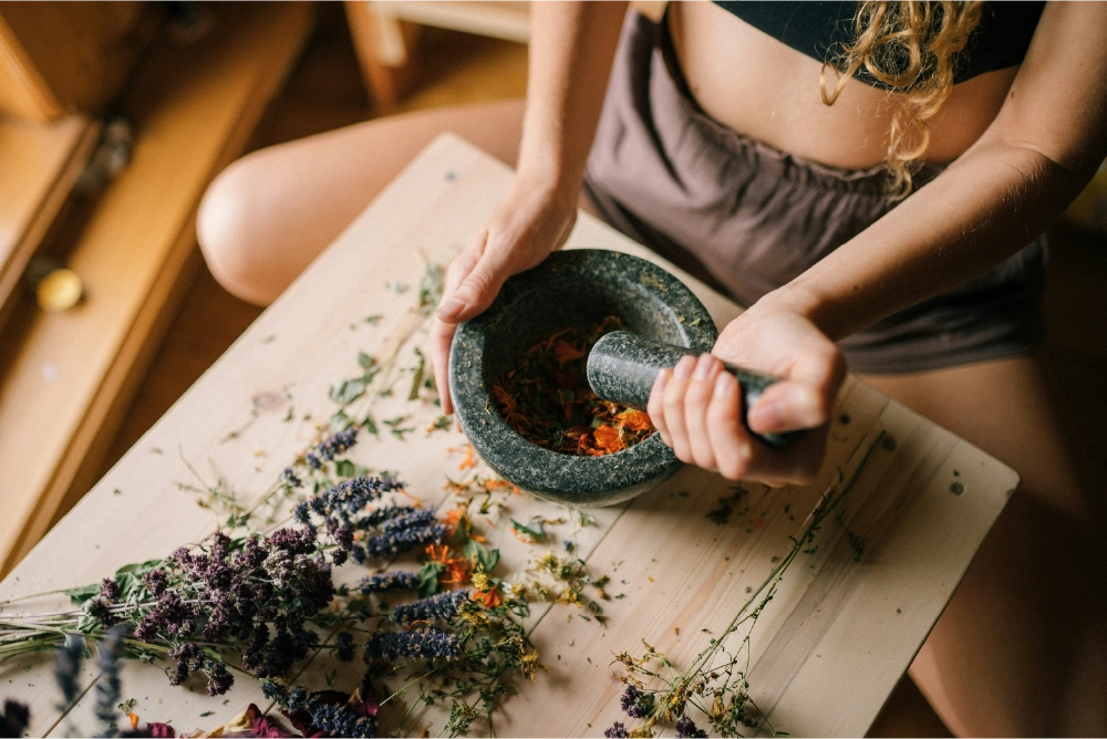 An experience witch crafting a magickal herbal blend for invoking magic.