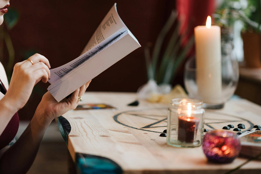 A beginner witch embarking her spiritual journey and reading into rituals and resources.